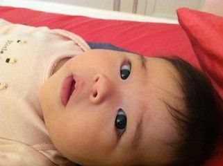 Cute baby girl laying down looking up