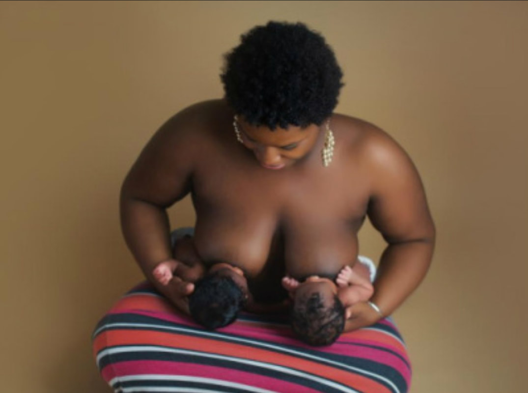 Mother breastfeeding twins
